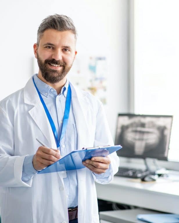 mature-dentist-in-modern-dental-surgery-looking-at-camera-pfmeaar6ugf64cxjyuv9wz3kwrgzbnaakfjaxkrax6